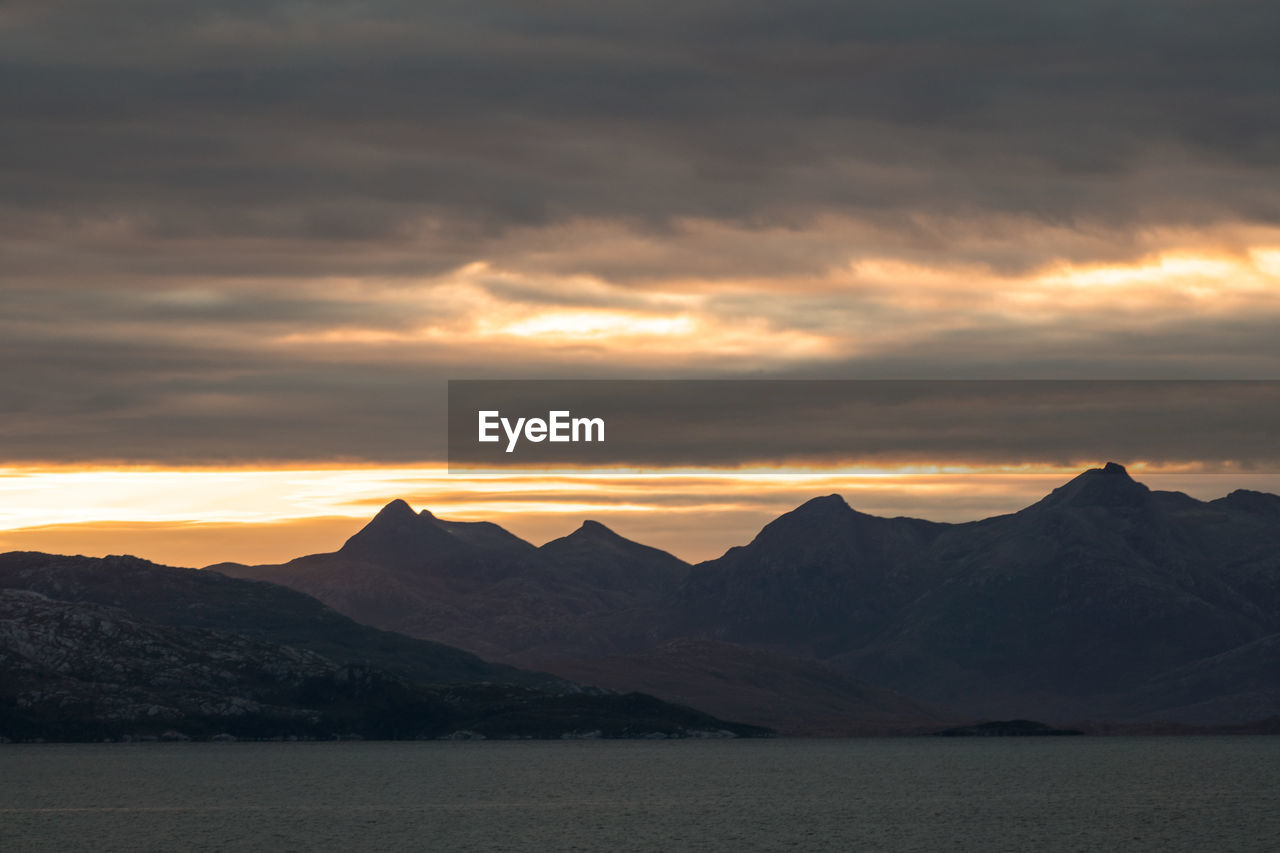 Scenic view of mountains against sky during sunset