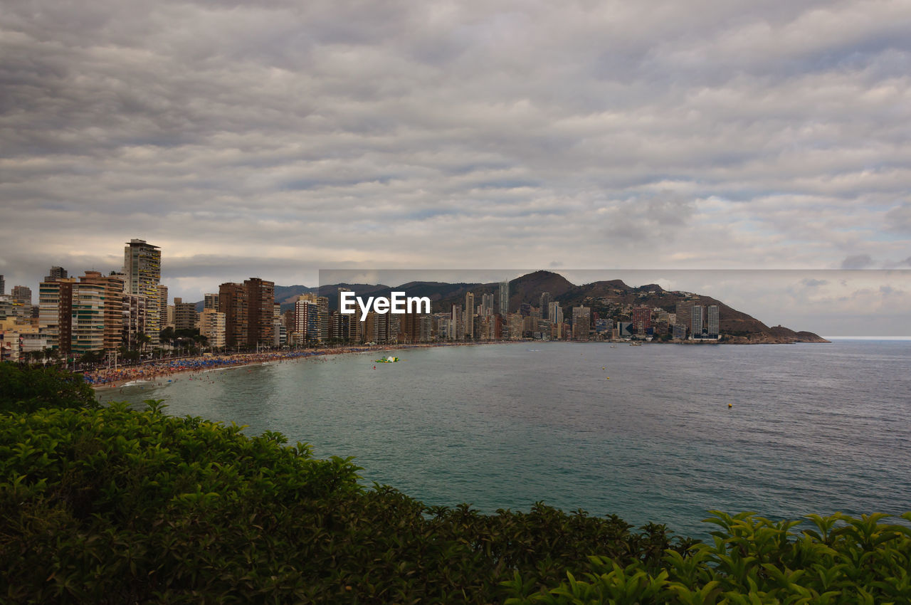 Scenic view of sea and buildings against sky