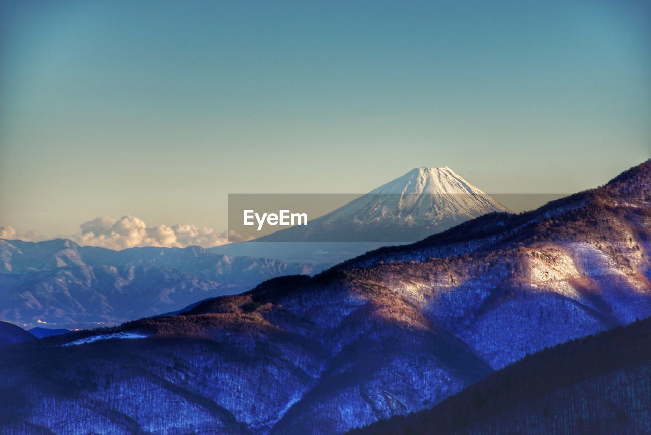 View of mountain range against blue sky