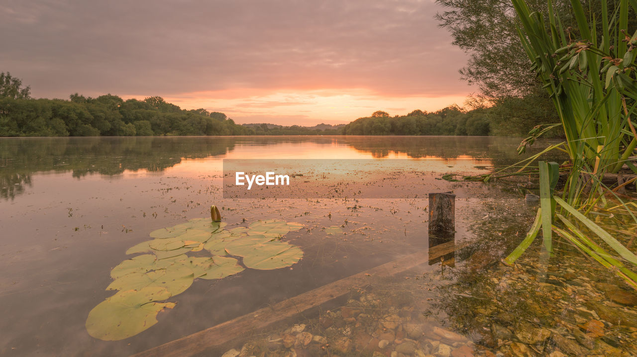 SCENIC VIEW OF LAKE AT SUNSET