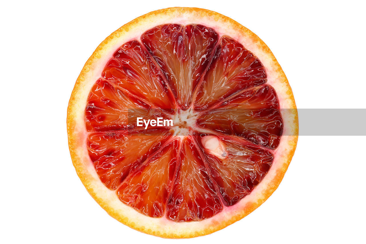 Close-up of halved orange against white background