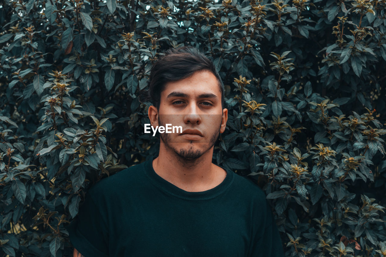 Portrait of man against plants