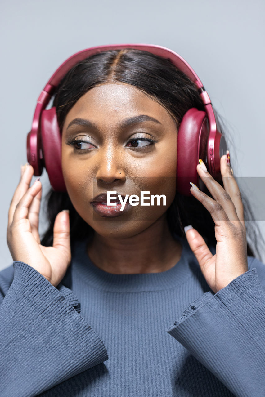 portrait of smiling young woman with eyes closed headphones