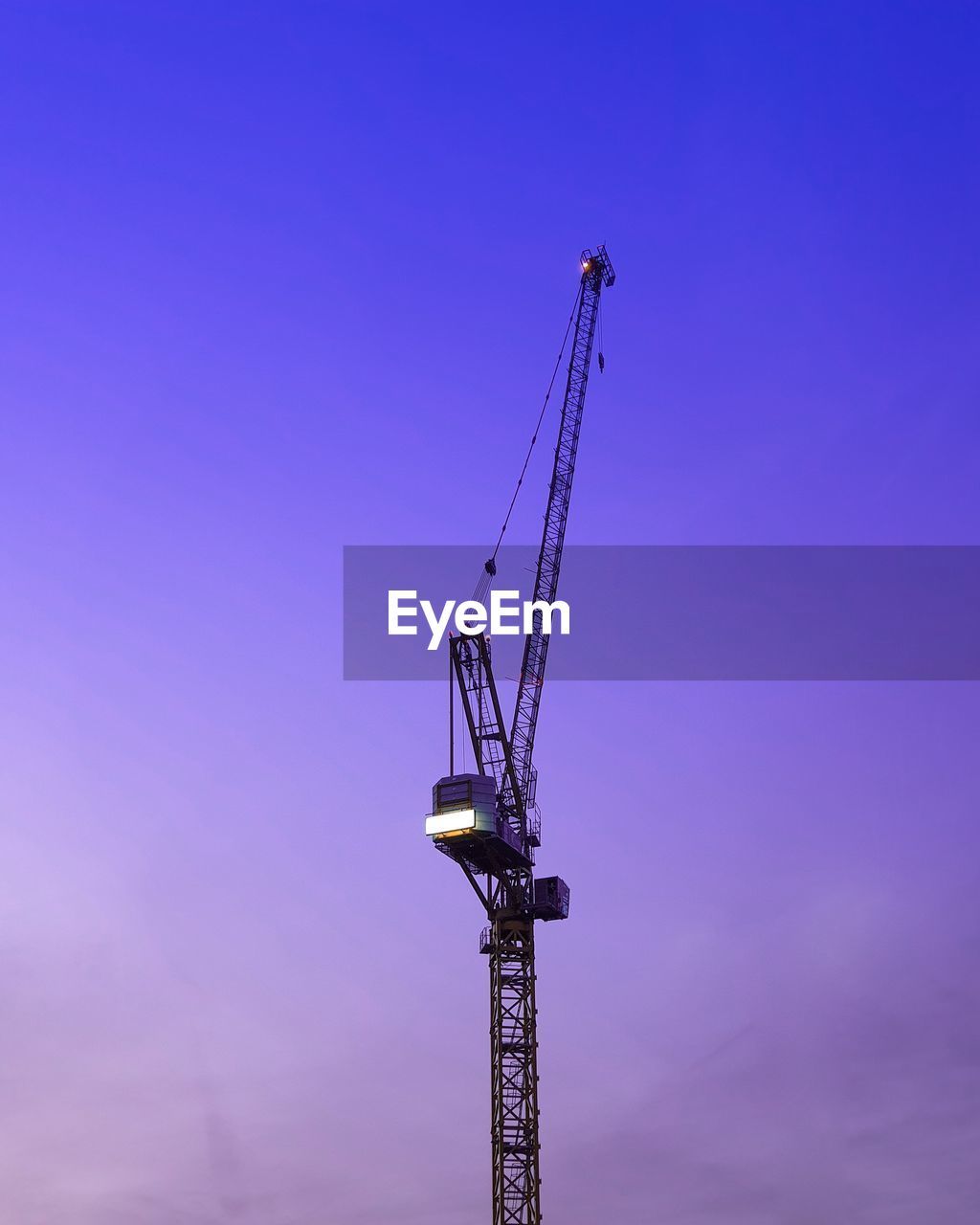 LOW ANGLE VIEW OF CRANE AT CONSTRUCTION SITE AGAINST BLUE SKY