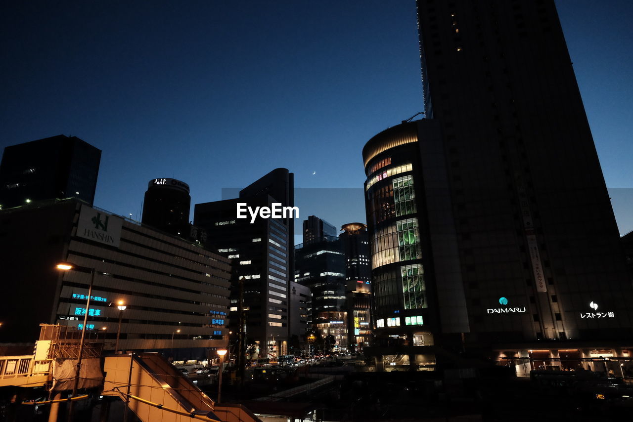 VIEW OF ILLUMINATED BUILDINGS AT NIGHT