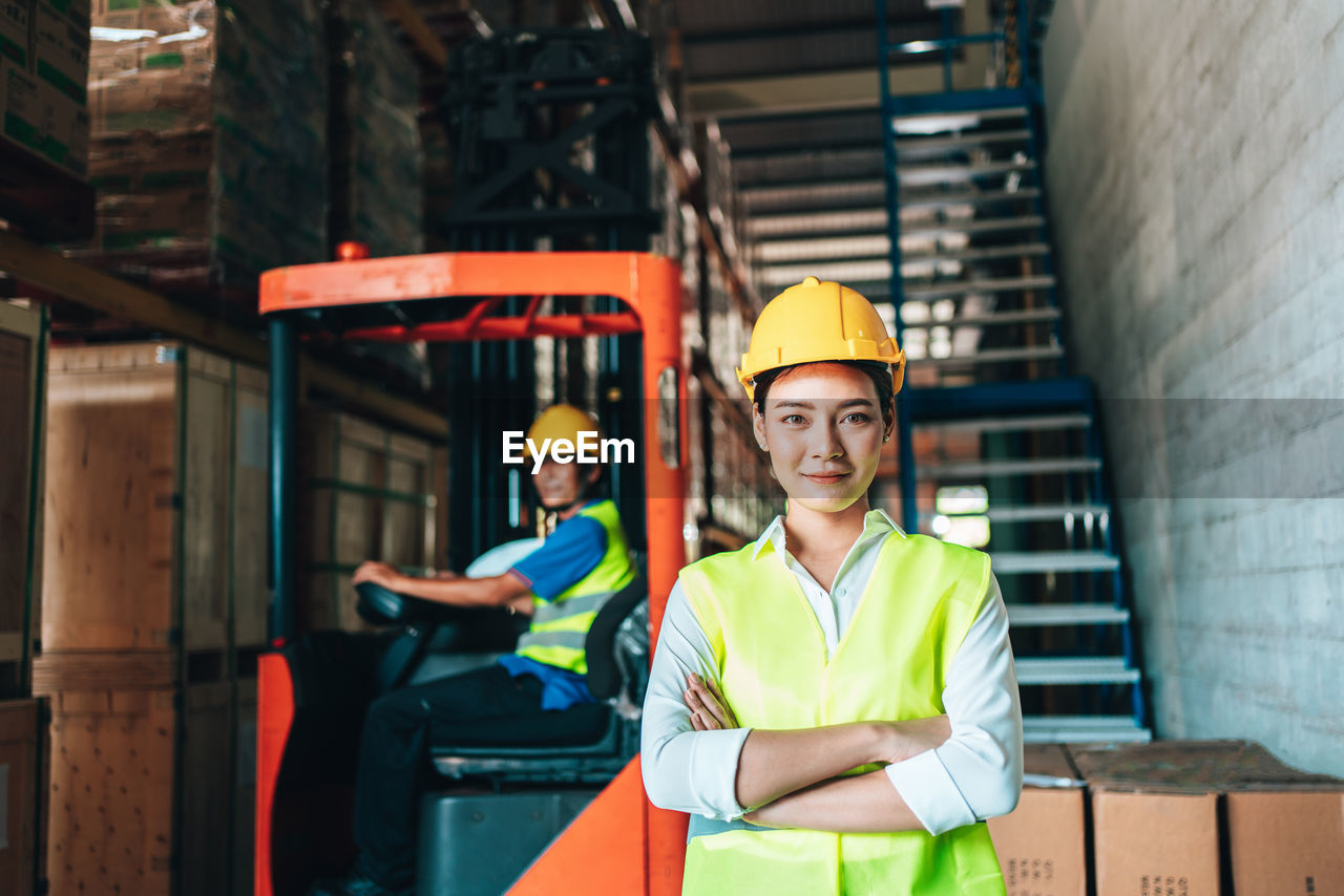 Portrait of engineer with arms crossed standing in factory