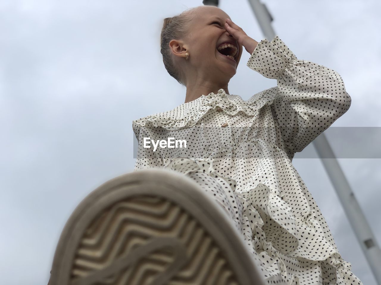 Low angle view of man looking at camera against sky