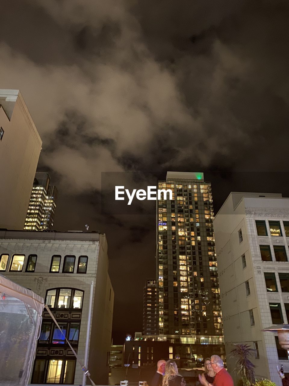 LOW ANGLE VIEW OF ILLUMINATED BUILDINGS IN CITY