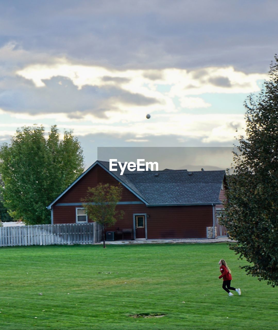 HOUSES ON FIELD AGAINST SKY