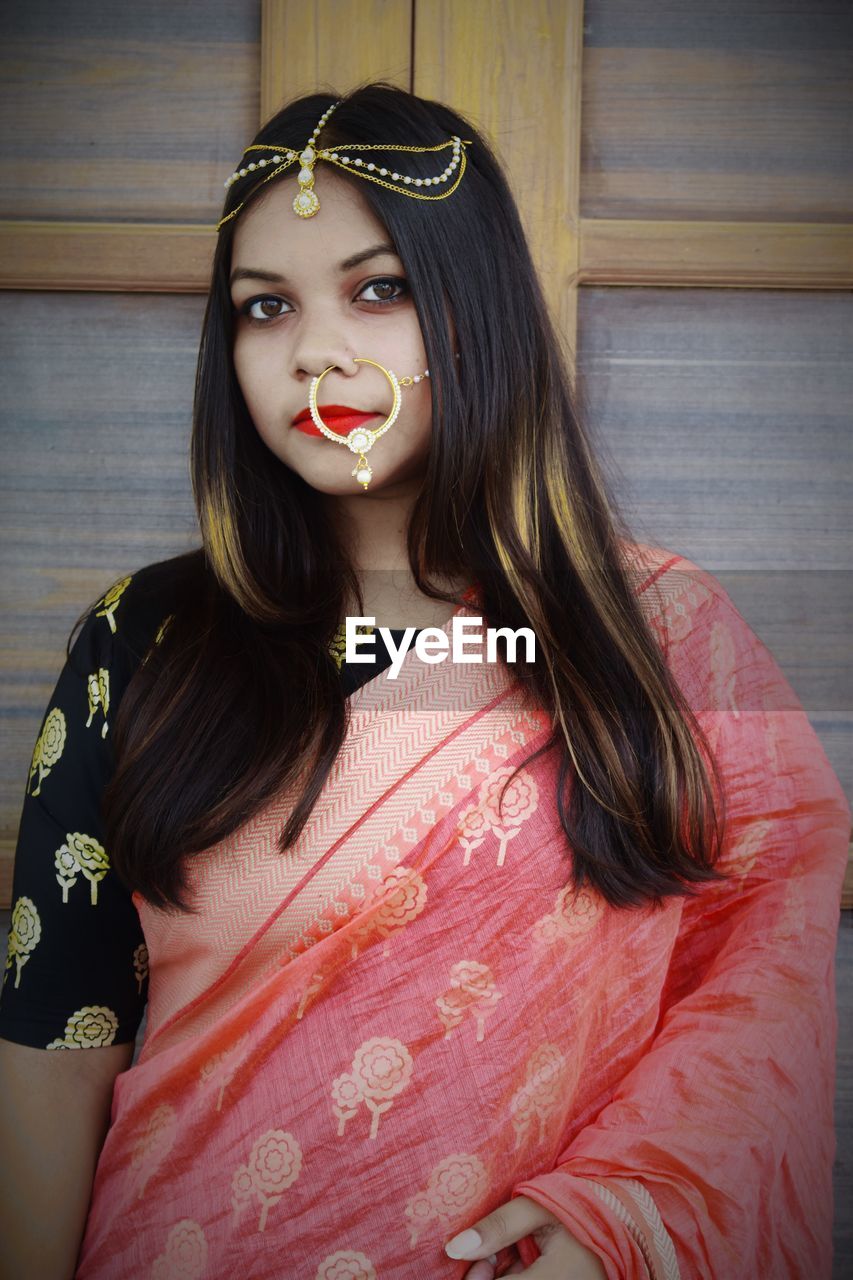 Portrait of female model in sari against wall