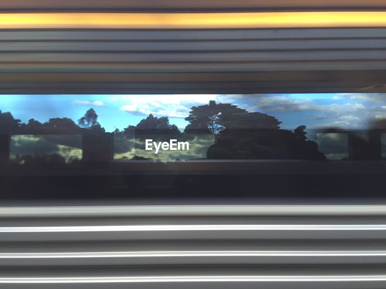 Passenger train with reflections on window