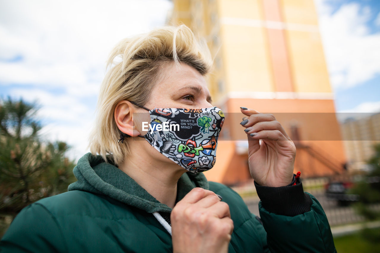 Young girl with short hair in protective mask.