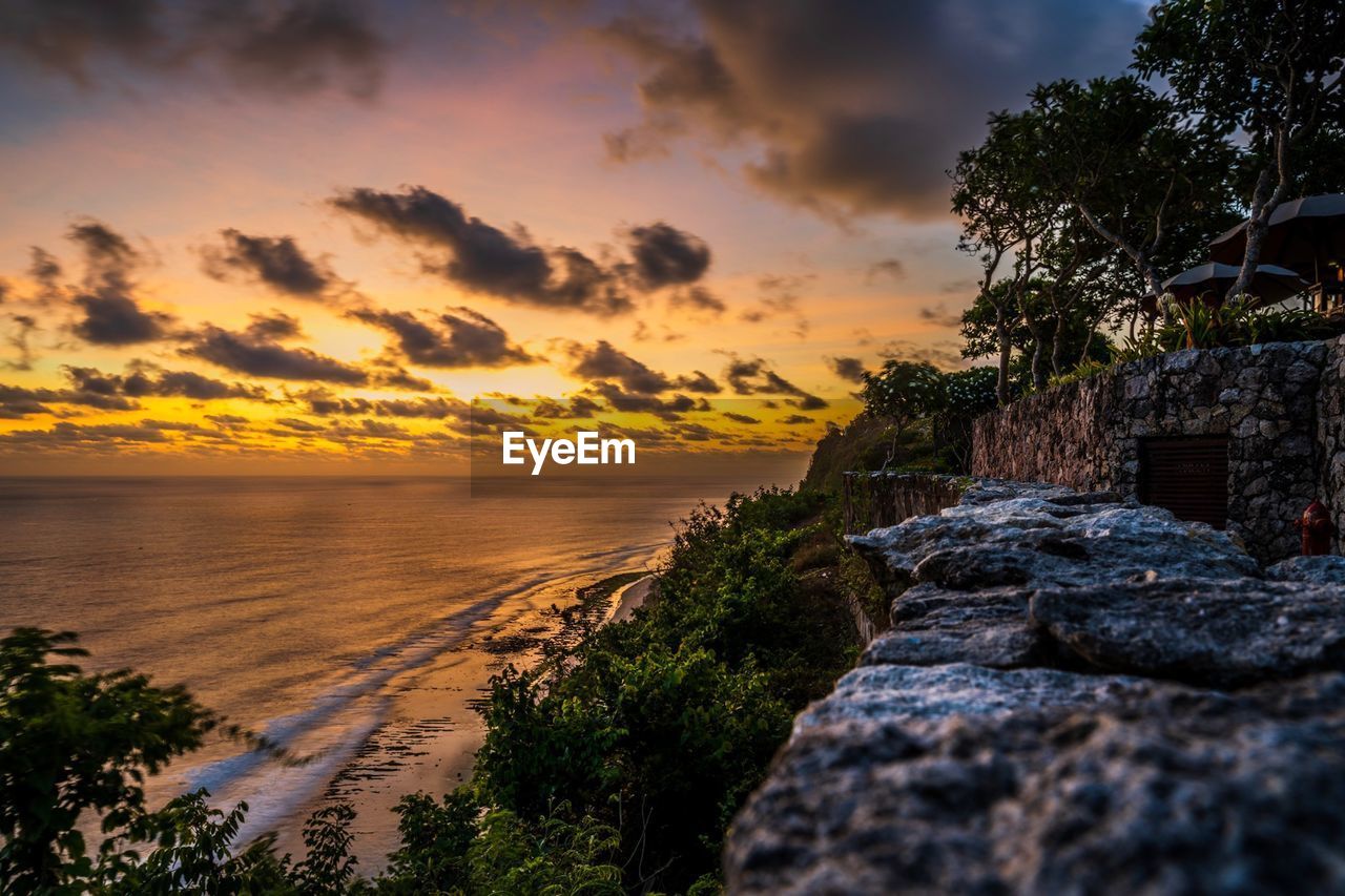 SCENIC VIEW OF BEACH DURING SUNSET