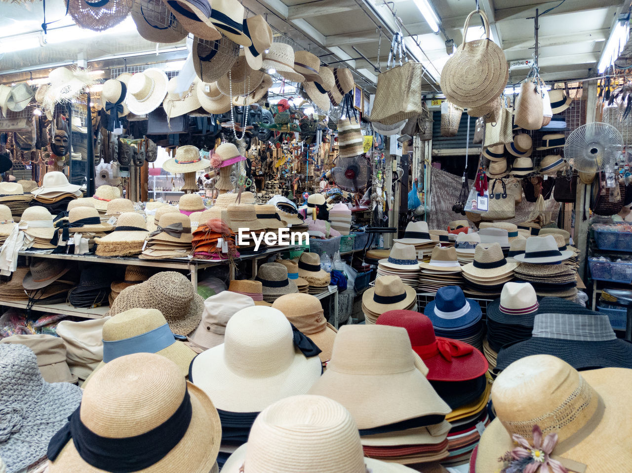 market, public space, city, retail, business, hat, large group of objects, for sale, clothing, marketplace, bazaar, flea market, abundance, fashion accessory, variation, small business, indoors, business finance and industry, store, cowboy hat, shopping, market stall, sun hat, no people, sale, day