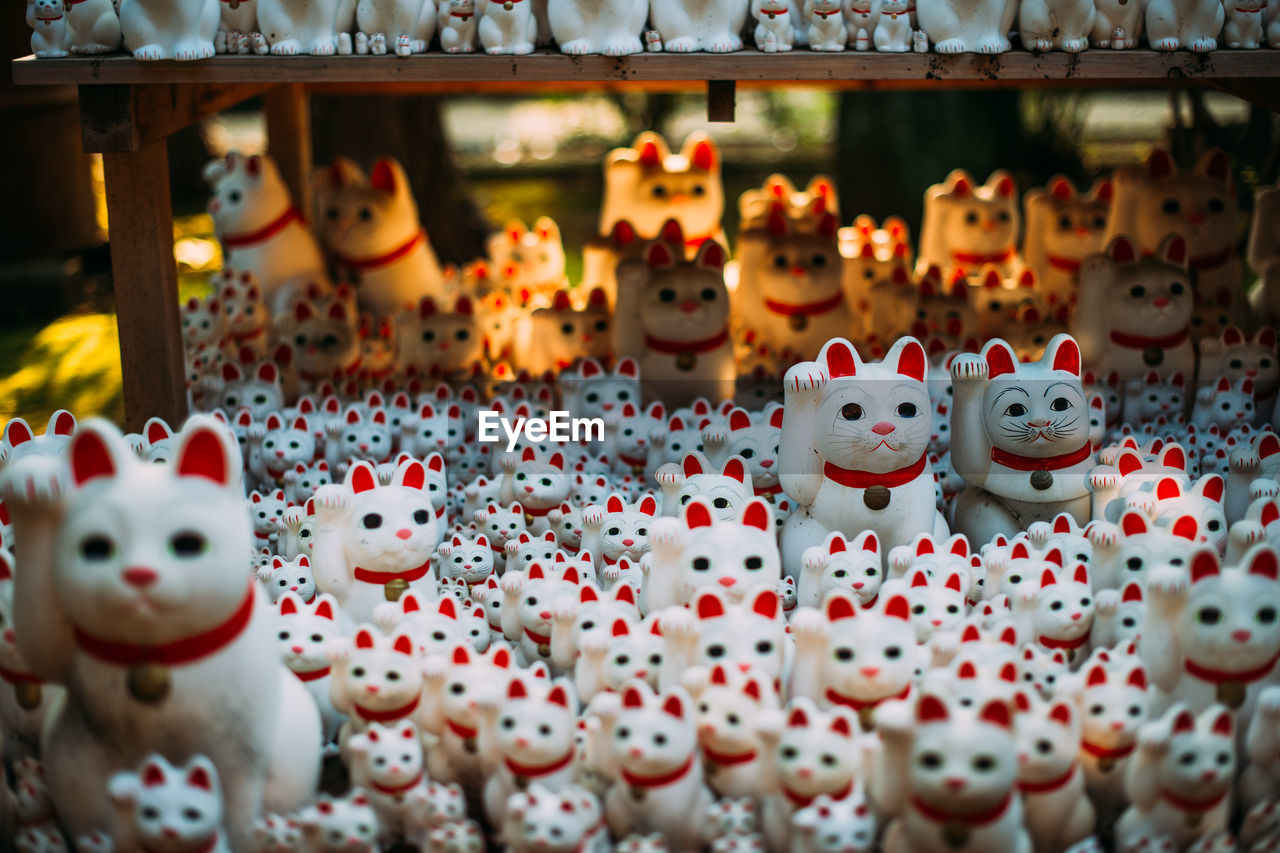 CLOSE-UP OF FIGURINES FOR SALE IN MARKET STALL