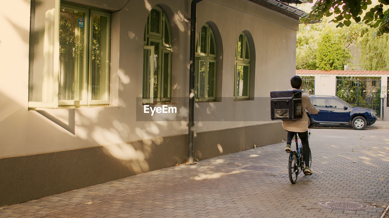 low section of man riding bicycle on street