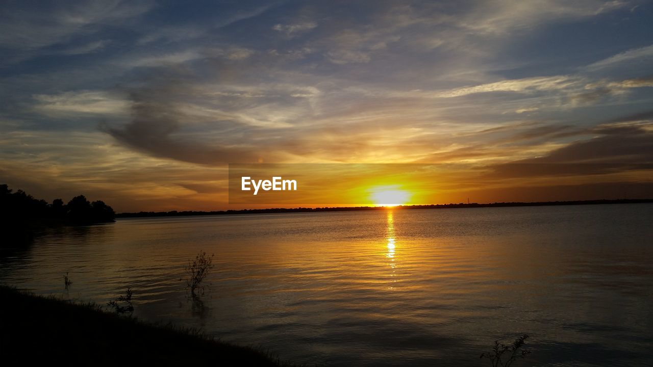 Scenic view of lake against sky during sunset