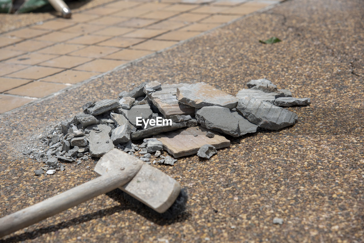 HIGH ANGLE VIEW OF STONES ON EMPTY ROAD