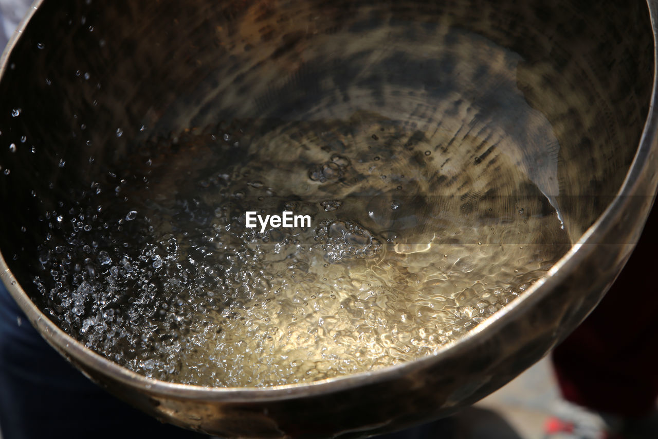 High angle view of water boiling in bowl