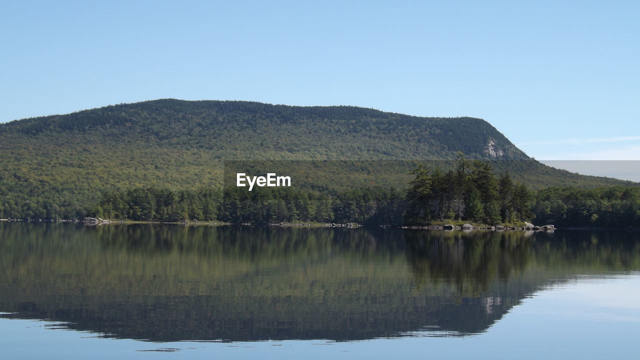 SCENIC VIEW OF LAKE WITH MOUNTAINS IN BACKGROUND