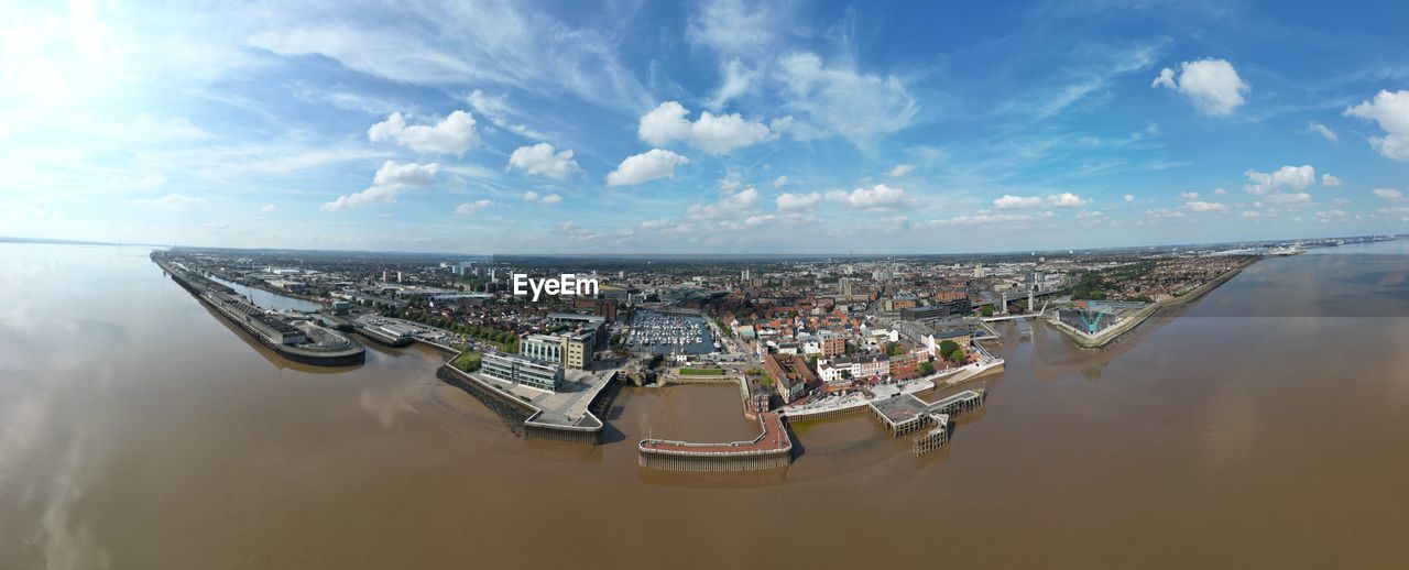 water, sky, cloud, aerial view, architecture, nature, reflection, panoramic, sea, city, nautical vessel, transportation, built structure, aerial photography, building exterior, horizon, cityscape, travel destinations, high angle view, outdoors, travel, day, building, no people, mode of transportation, business, vehicle, landscape, fisheye lens, urban skyline, scenics - nature, horizon over water