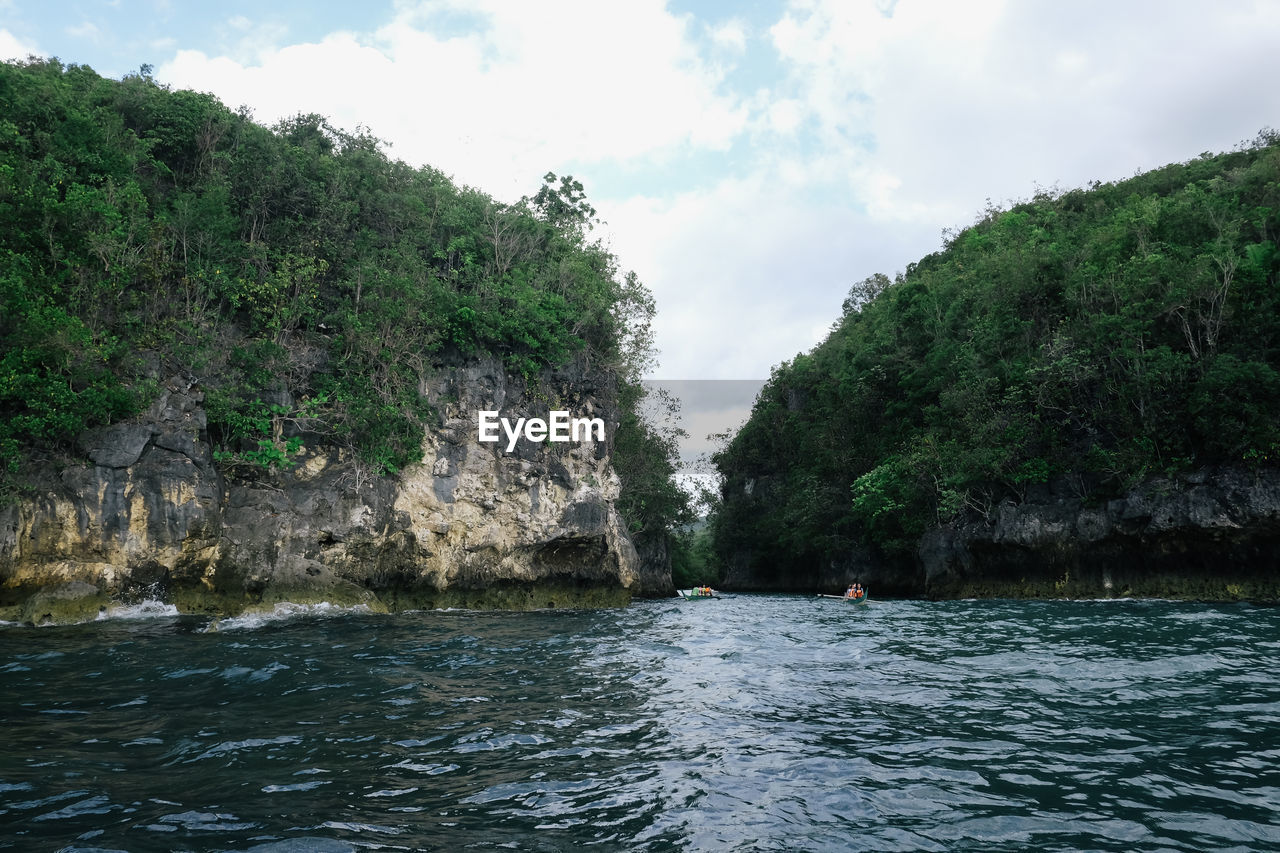 Scenic view of river against cloudy sky