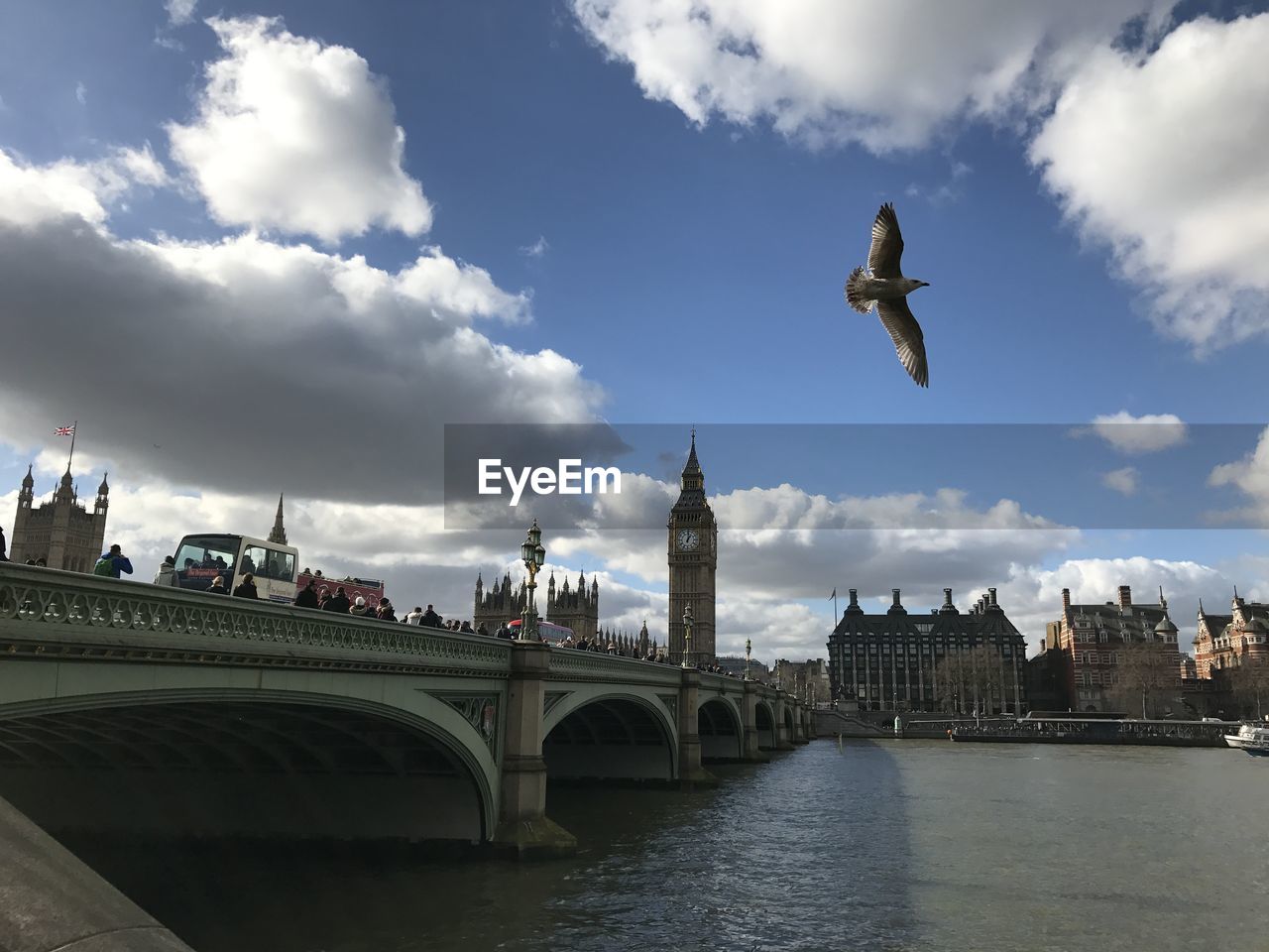 BRIDGE OVER RIVER AGAINST CLOUDY SKY