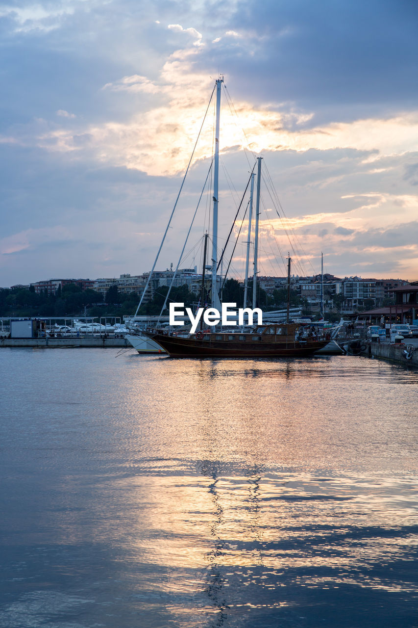 SAILBOATS IN HARBOR AT SUNSET