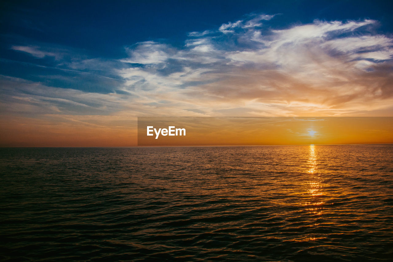SCENIC VIEW OF SEA DURING SUNSET