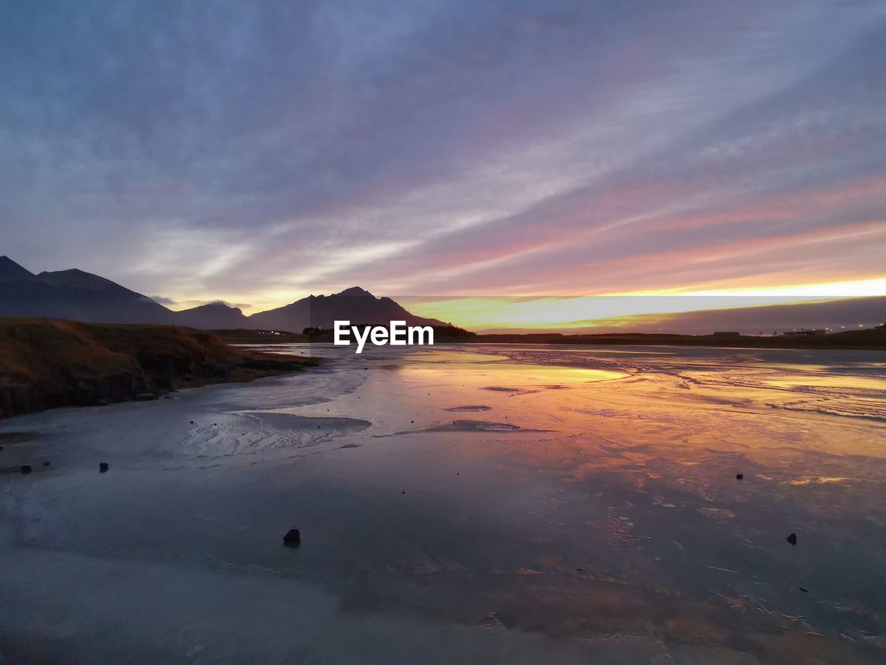 Scenic view of beach against sky during sunset