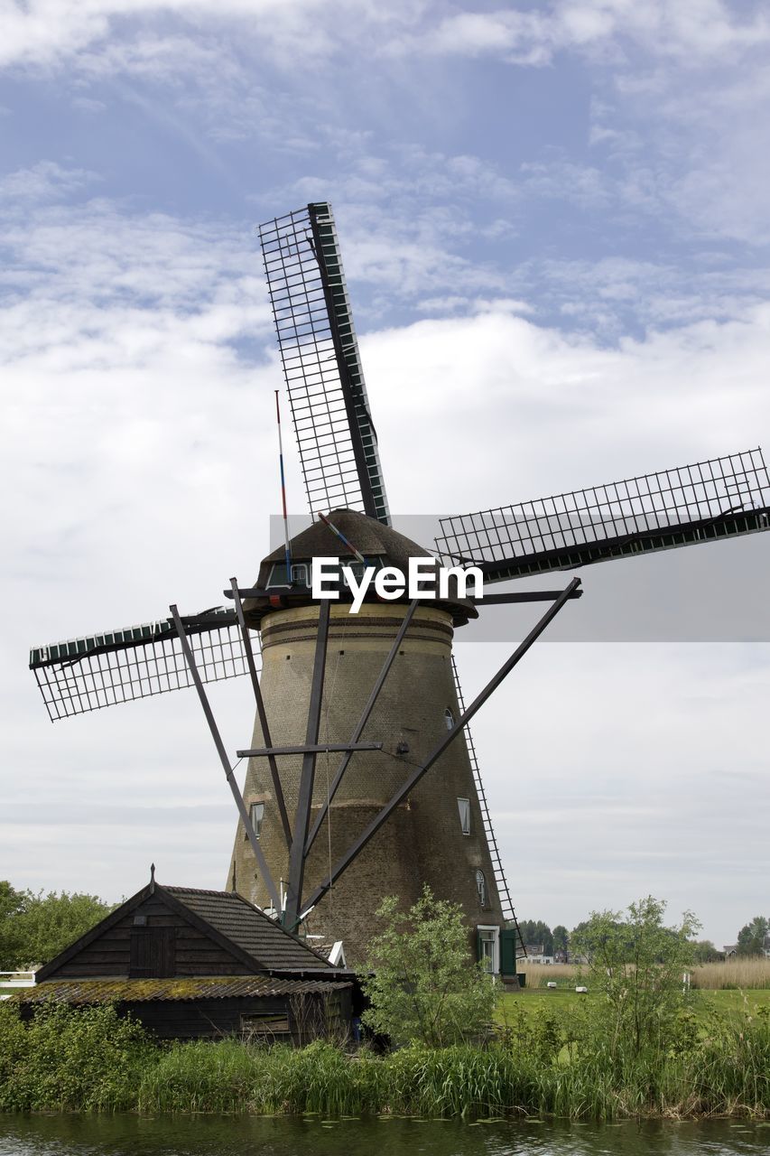 Low angle view of windmill against sky