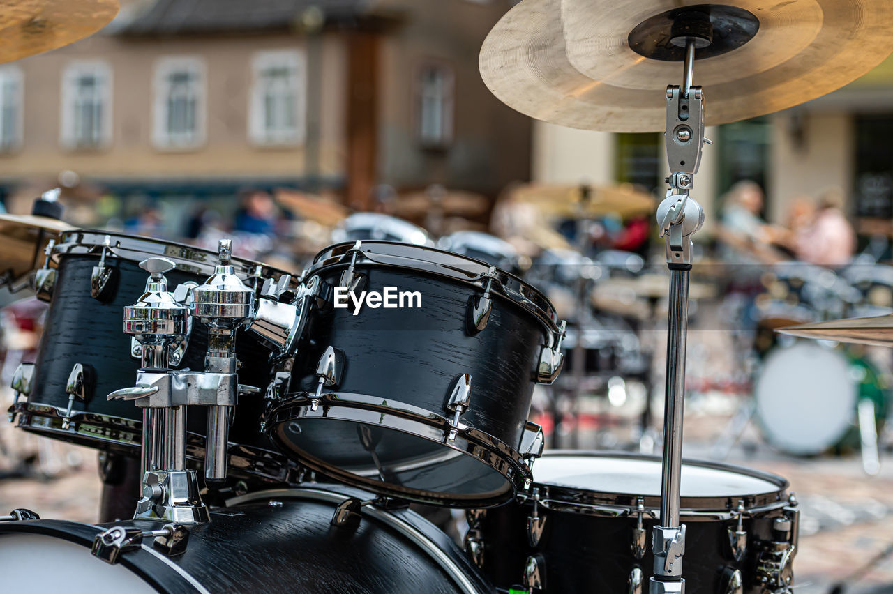 A set of plates in a drum set. at a concert of percussion music, selective focus, close-up