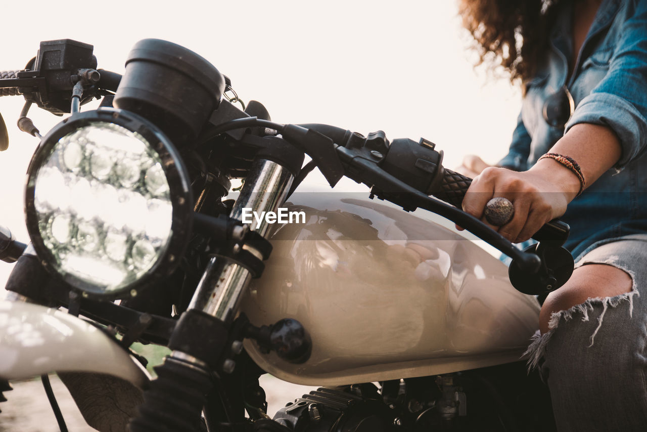 Midsection of woman riding motorcycle