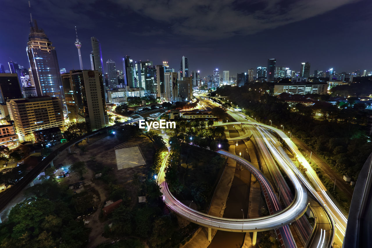 Illuminated cityscape against sky at night