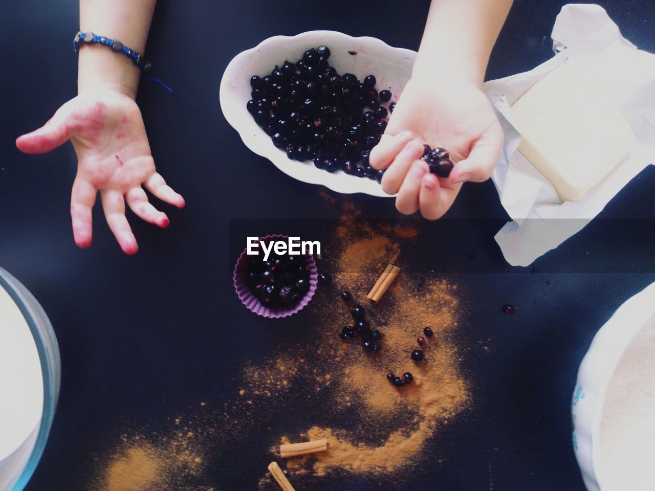 HIGH ANGLE VIEW OF HANDS PREPARING FOOD