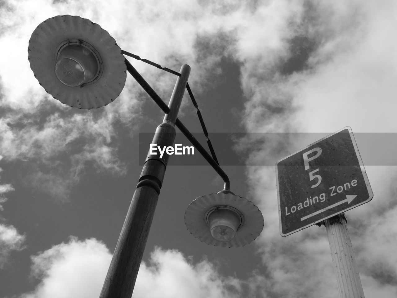 LOW ANGLE VIEW OF ROAD SIGN AGAINST CLOUDY SKY