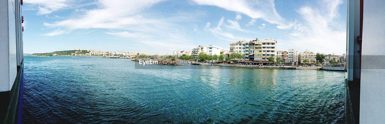 VIEW OF SEA WITH BUILDINGS IN BACKGROUND