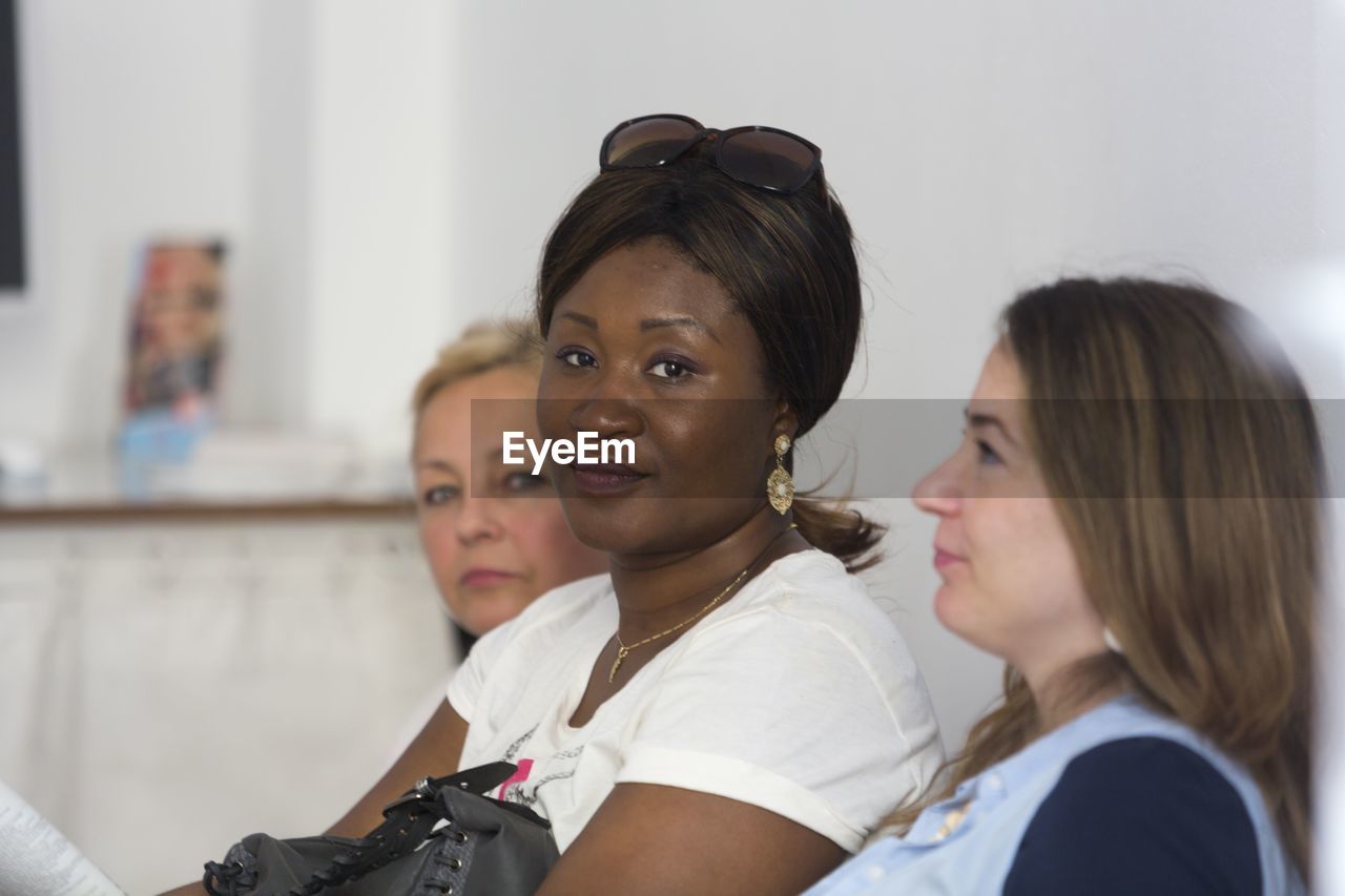 Portrait of woman with friends in clinic