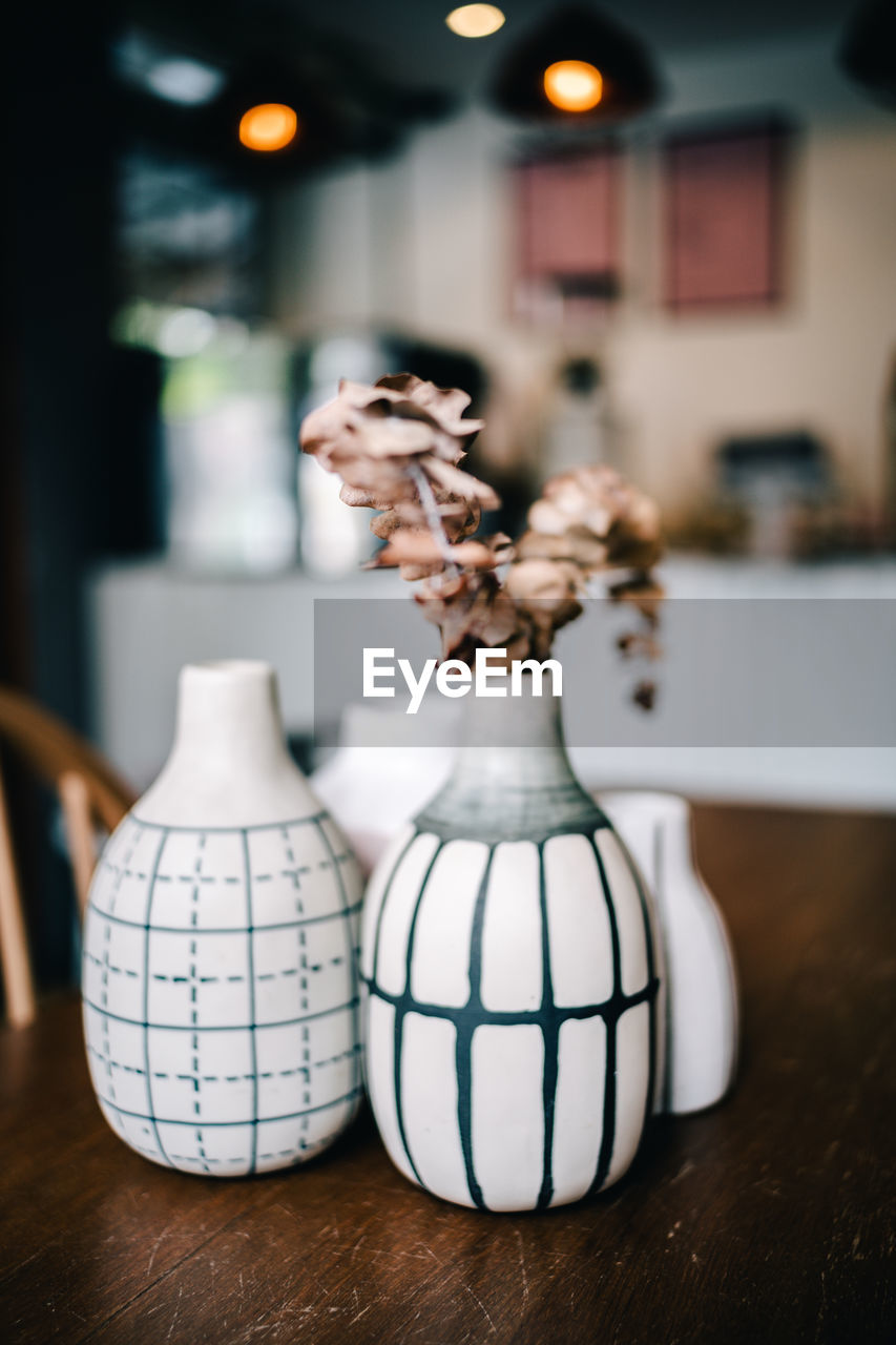 Close-up of flower vase on table at home