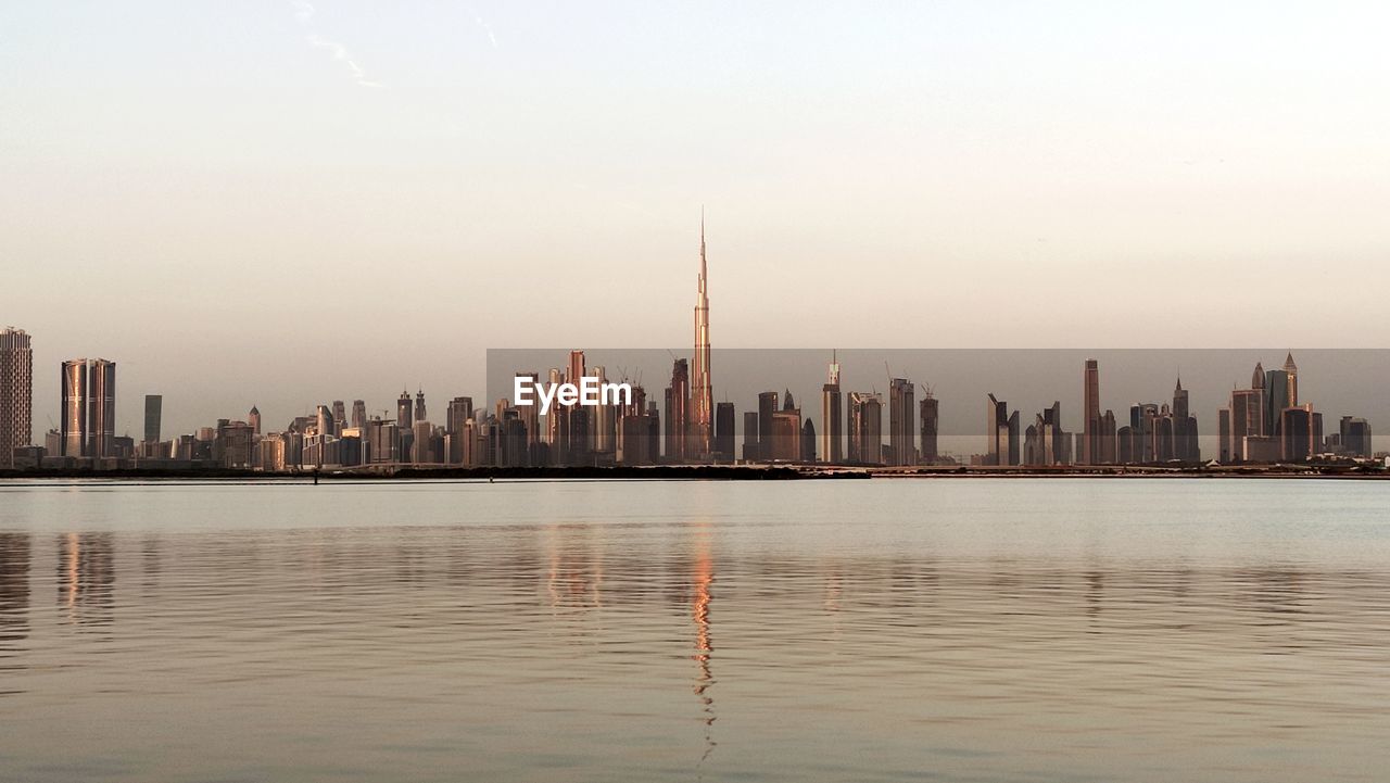 city, architecture, building exterior, built structure, skyline, landscape, building, urban skyline, office building exterior, skyscraper, sky, horizon, cityscape, water, reflection, morning, nature, travel destinations, dusk, downtown district, downtown, residential district, city life, no people, office, waterfront, tower, river, travel, outdoors, business, environment, urban area, scenics - nature