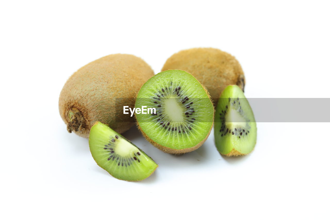 kiwifruit, healthy eating, food, food and drink, fruit, kiwi, wellbeing, freshness, white background, studio shot, cut out, produce, cross section, slice, indoors, green, no people, plant, group of objects, still life, tropical fruit, seed, close-up, ripe