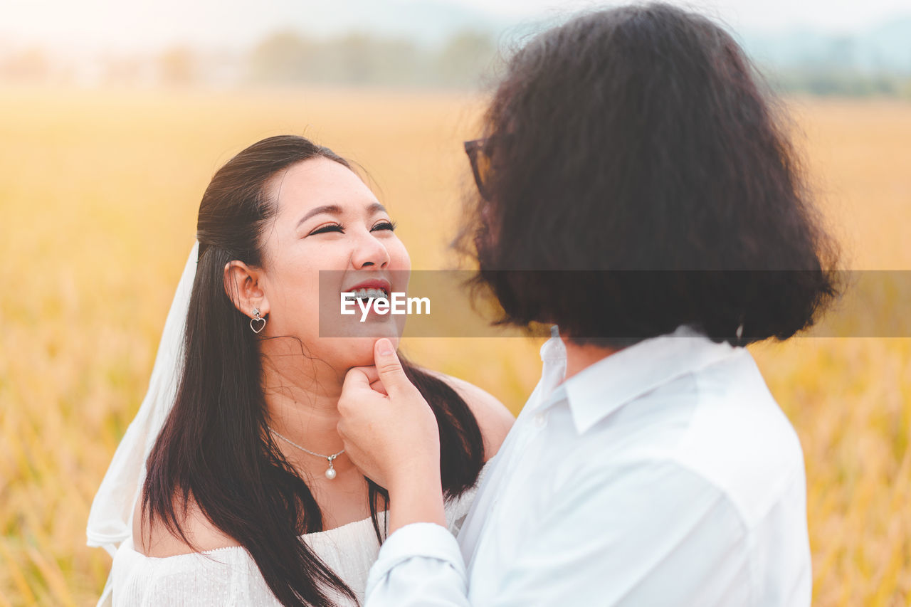 Happy lesbian couple standing on land