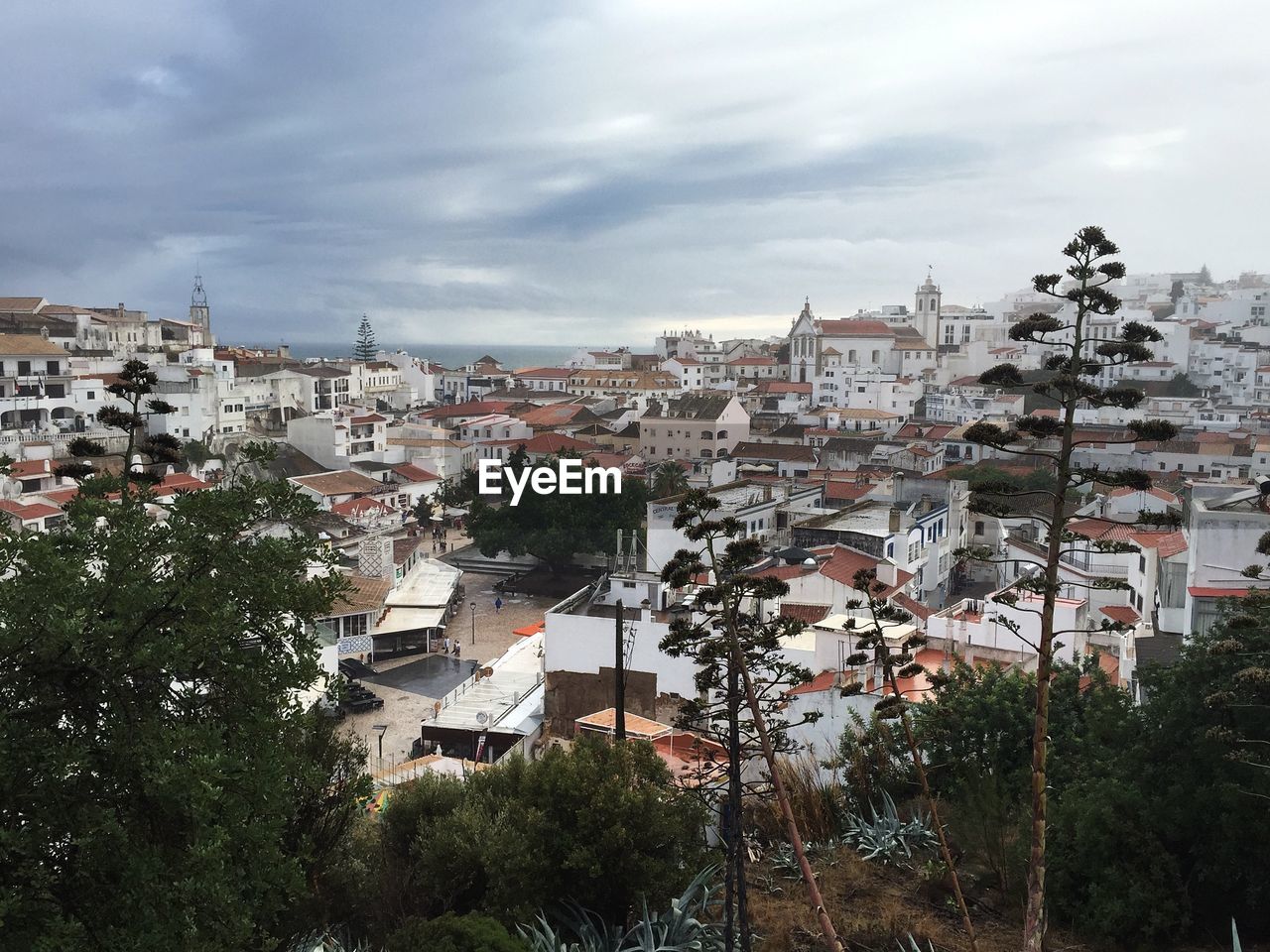 High angle view of cityscape against cloudy sky