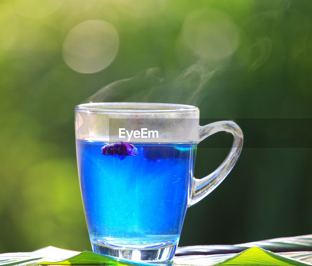 CLOSE-UP OF COFFEE CUP ON GLASS