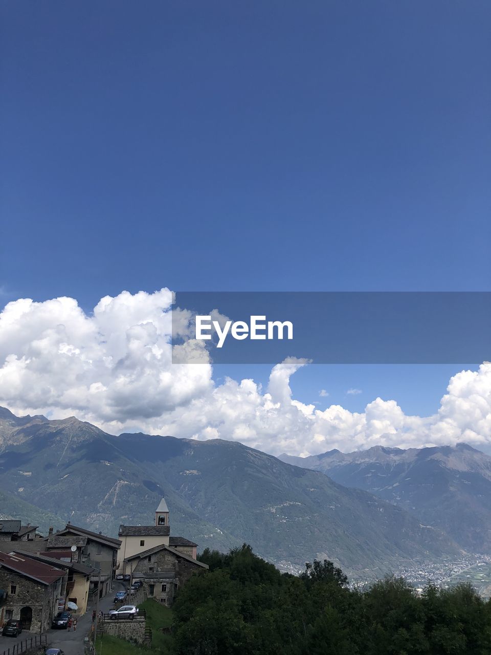 sky, cloud, nature, blue, day, mountain, beauty in nature, mountain range, outdoors, environment, no people, sunlight, snow, scenics - nature, tree, white, architecture, travel, low angle view