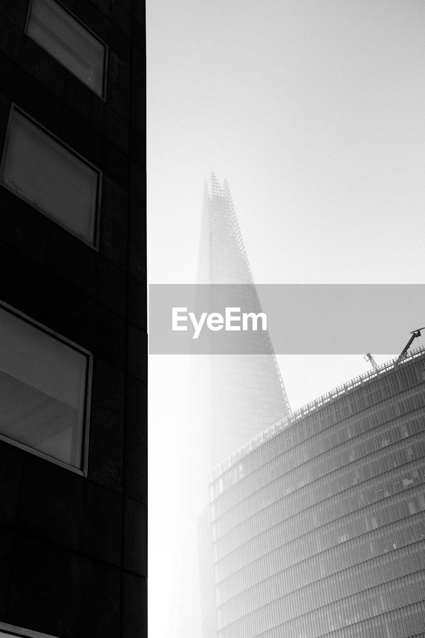 LOW ANGLE VIEW OF MODERN BUILDINGS AGAINST SKY