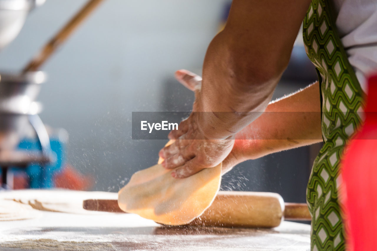 Low section of man making chapatti