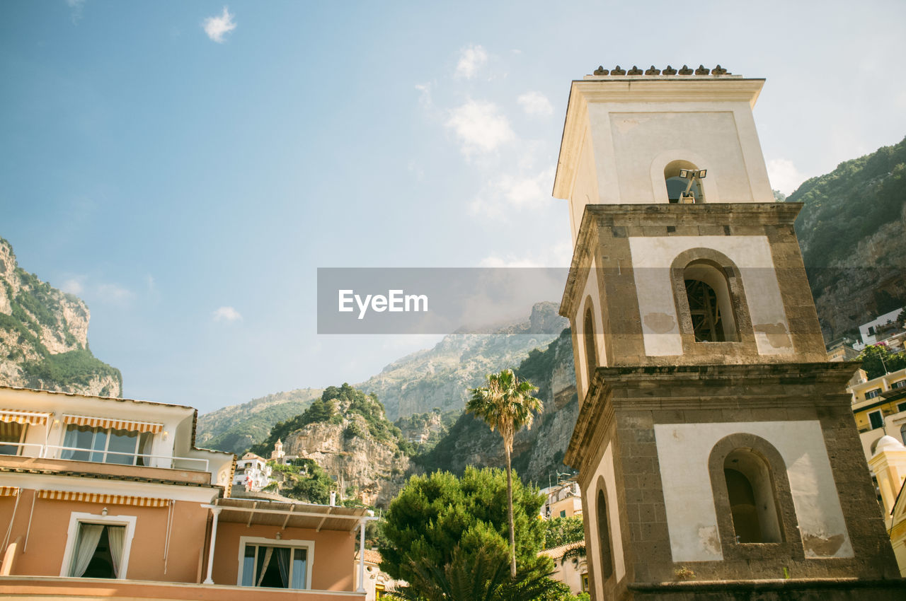 Low angle view of building and mountains at positano