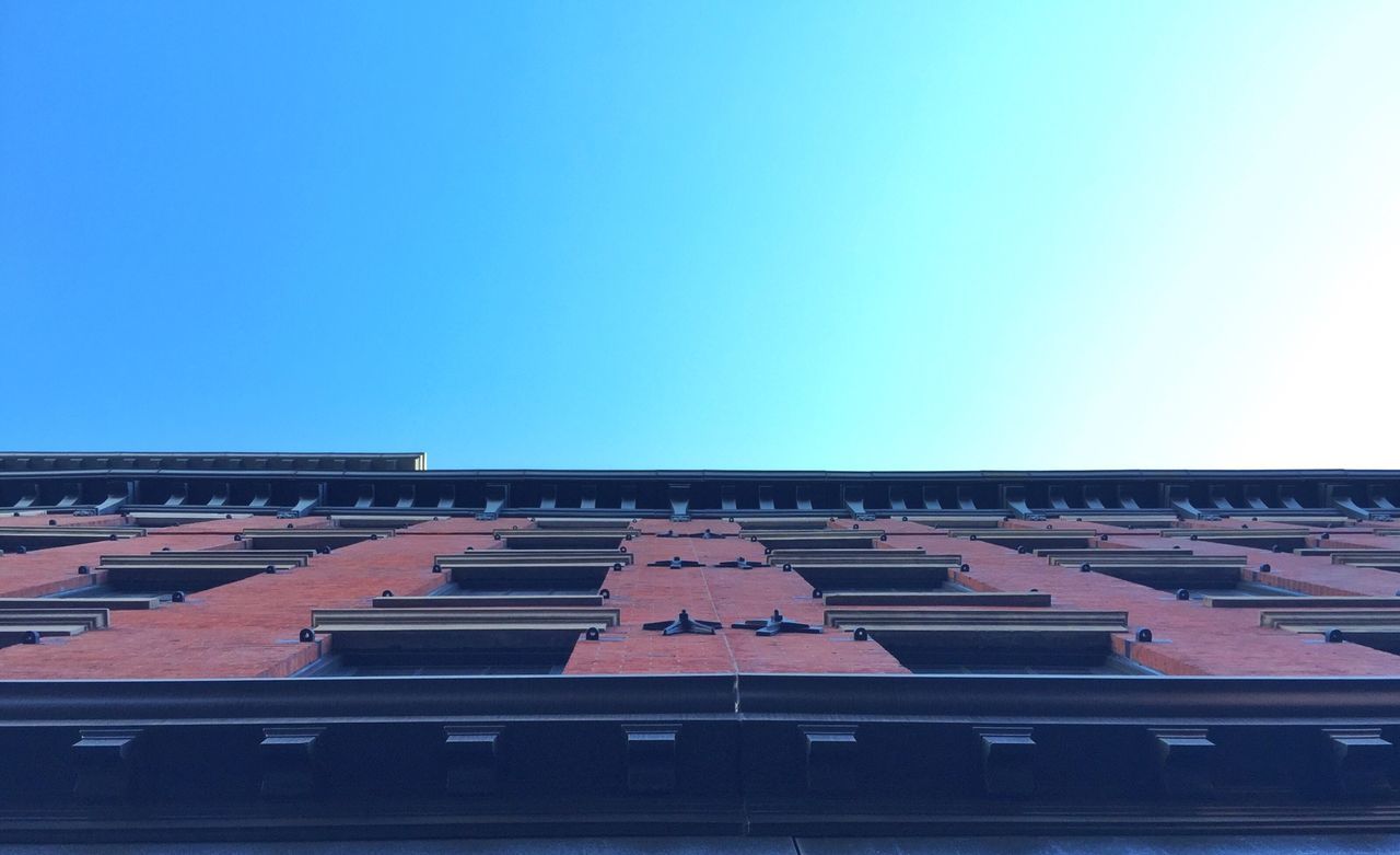 LOW ANGLE VIEW OF BUILDINGS AGAINST BLUE SKY