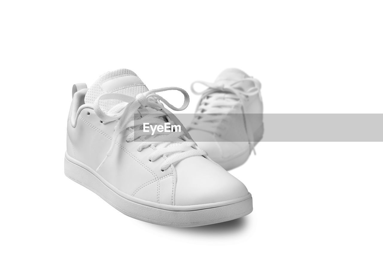 LOW ANGLE VIEW OF SHOES AGAINST WHITE BACKGROUND